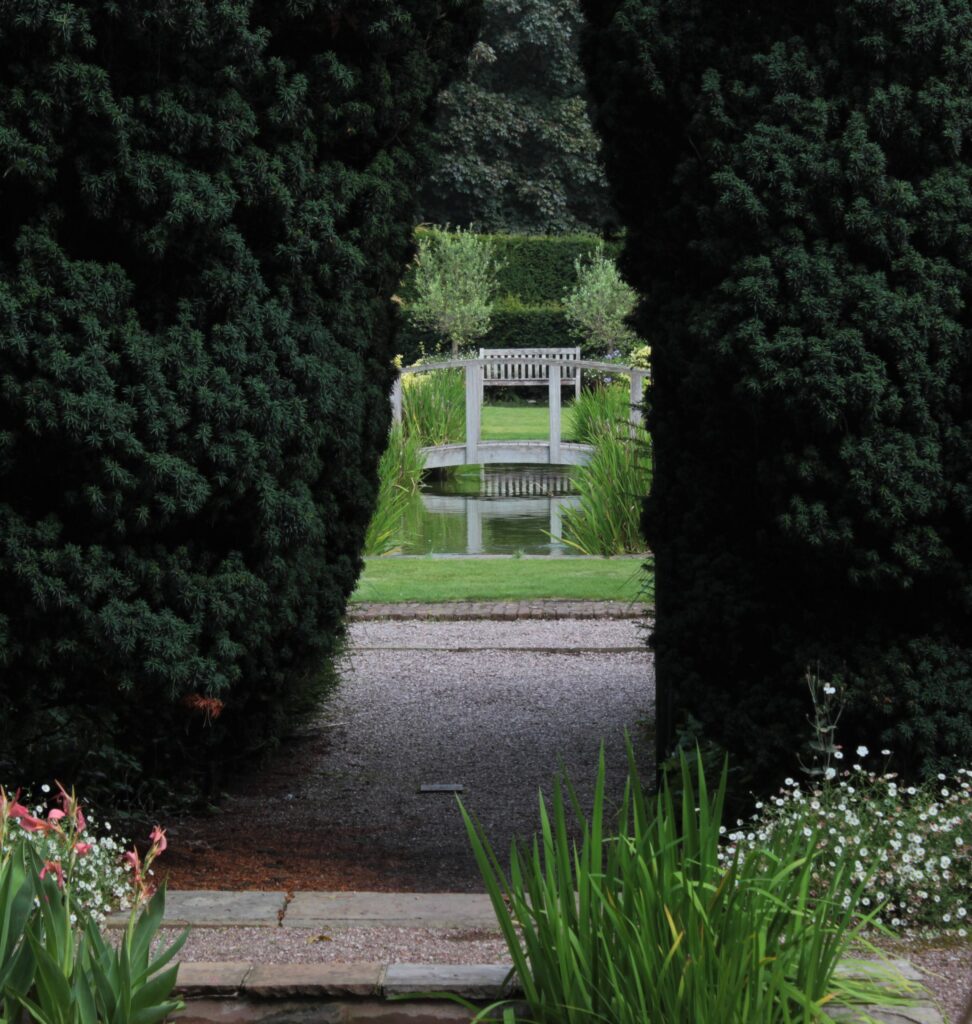 View of Pool Garden through Hedge